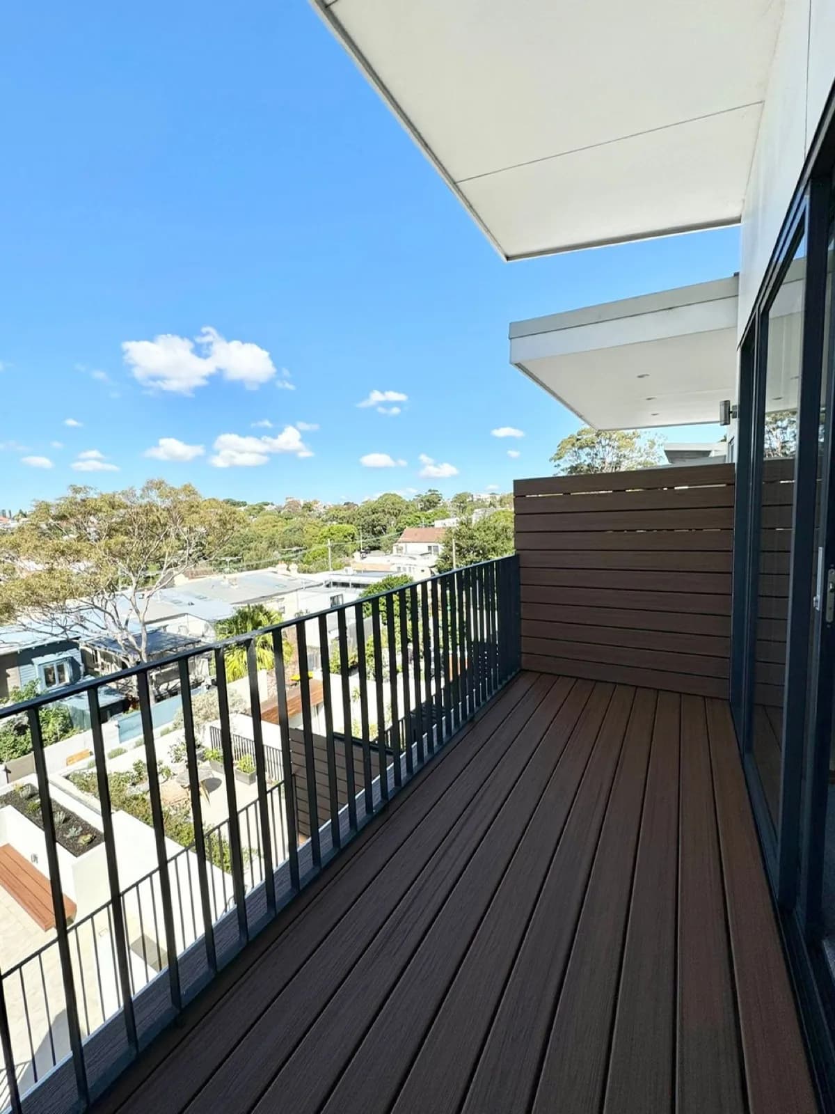 Narrow balcony deck with railing, skyline