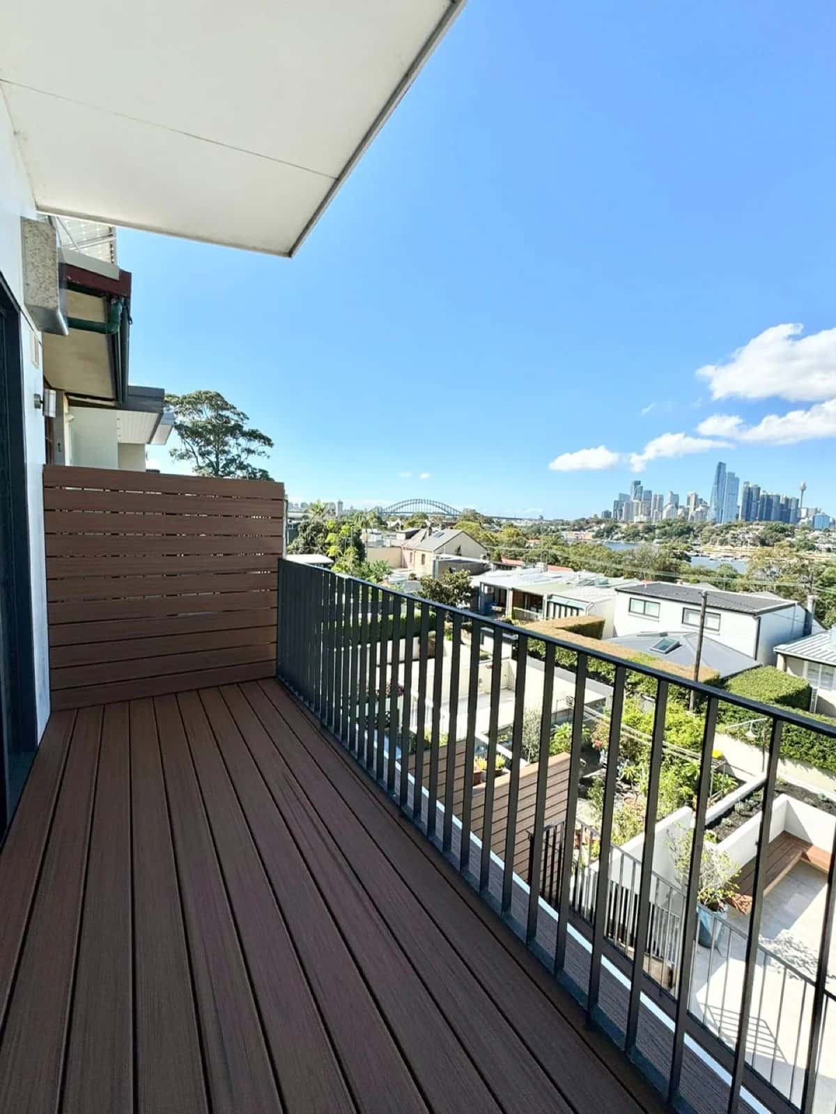 Narrow balcony deck with screen, skyline and harbour