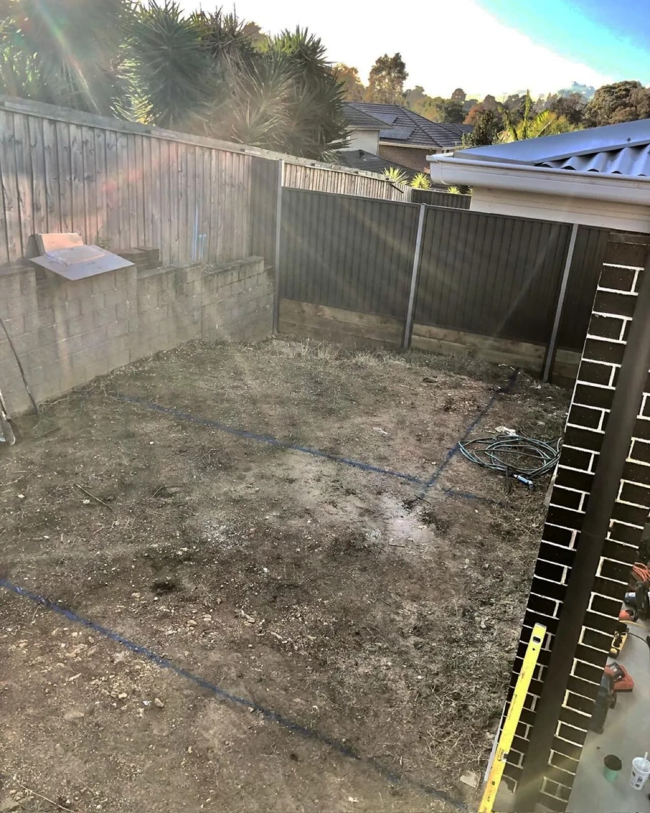 Before work started: bare dirt yard with string lines set out