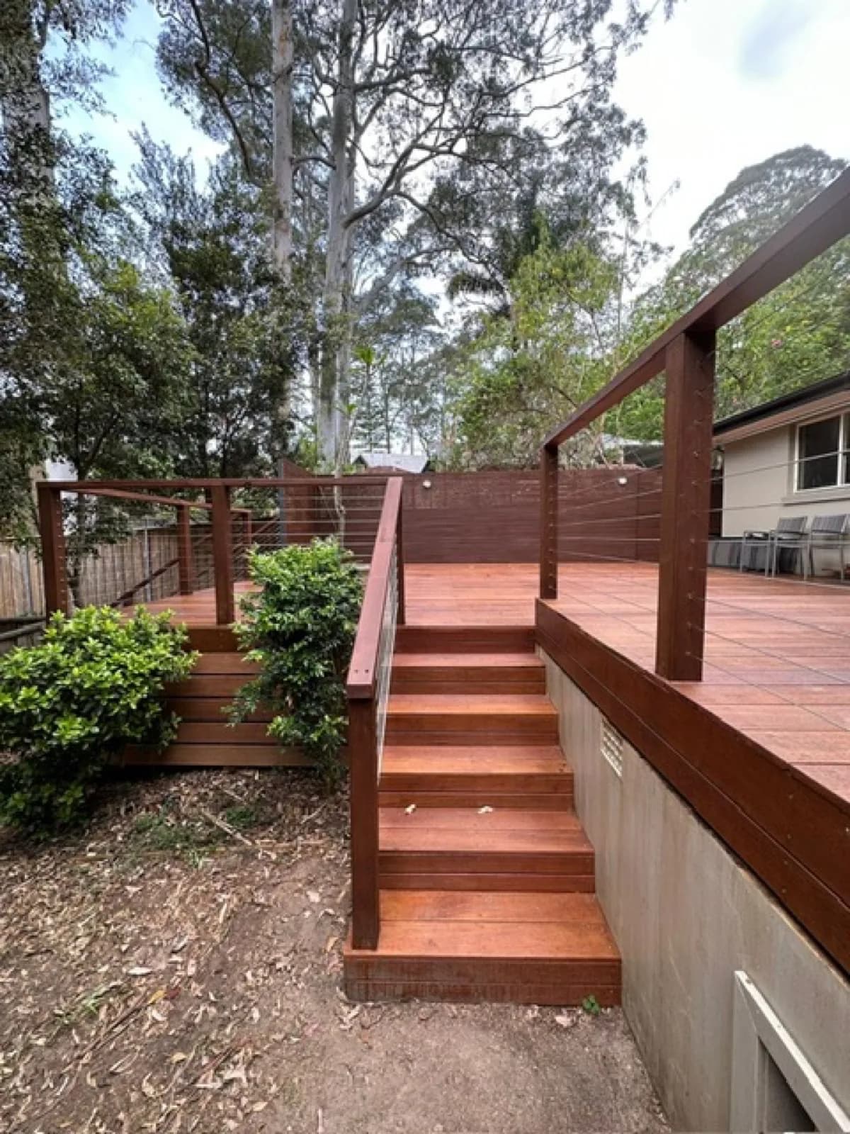 Merbau stairs with timber handrail and wire balustrade from garden